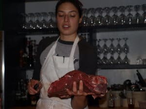 Sara Bigelow of the Meat Hook performs a meat cutting demonstration.