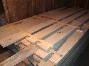 Lumber should be stickered immediately after sawing, ideally as the boards come off the mill.  In door storage, as illustrated, is ideal if space is available.
