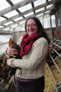 Karma Glos of Kingbird Farm holds one of her chickens. 